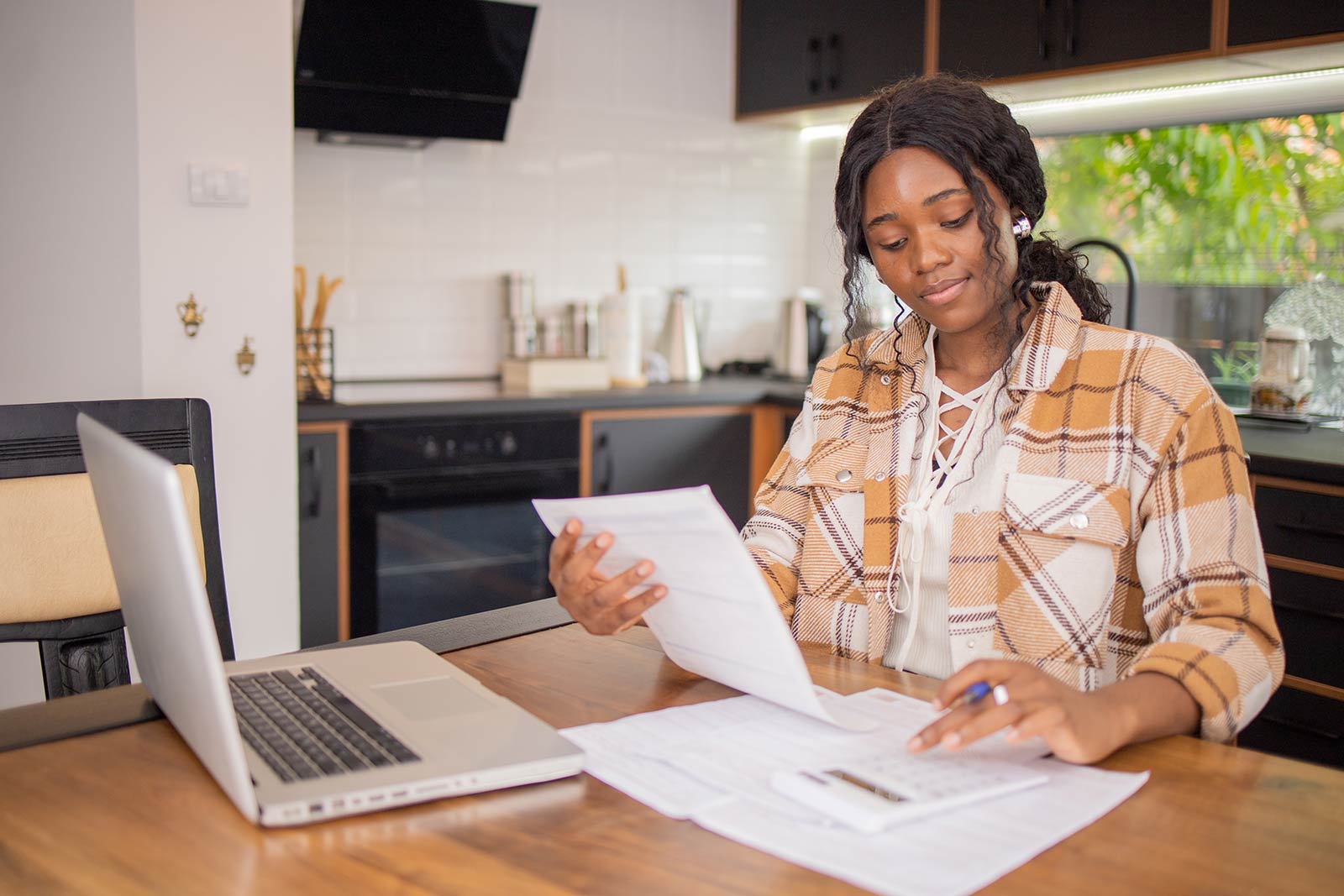 Woman working with a calculator and computer