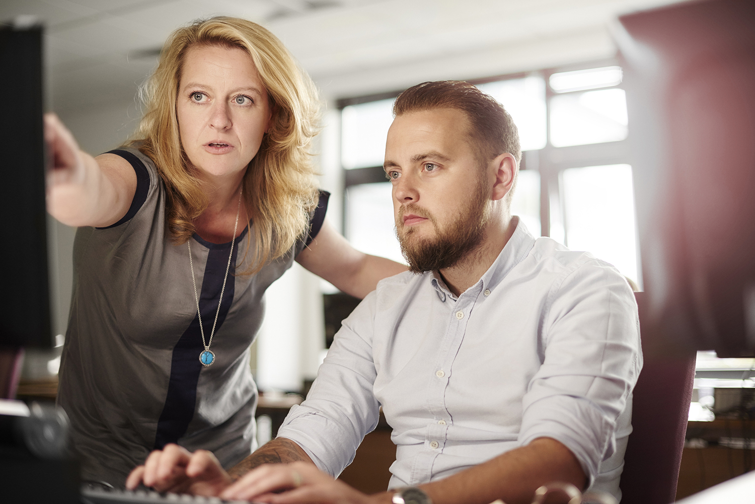 Image of women helping older student on computer