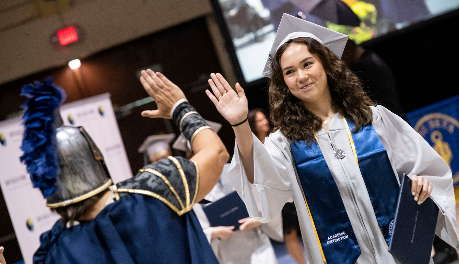 Honors student high fives Titus the Titan