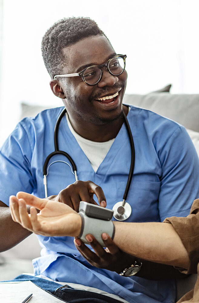 Image of a male nurse taking blood pressure of a male senior citizen
