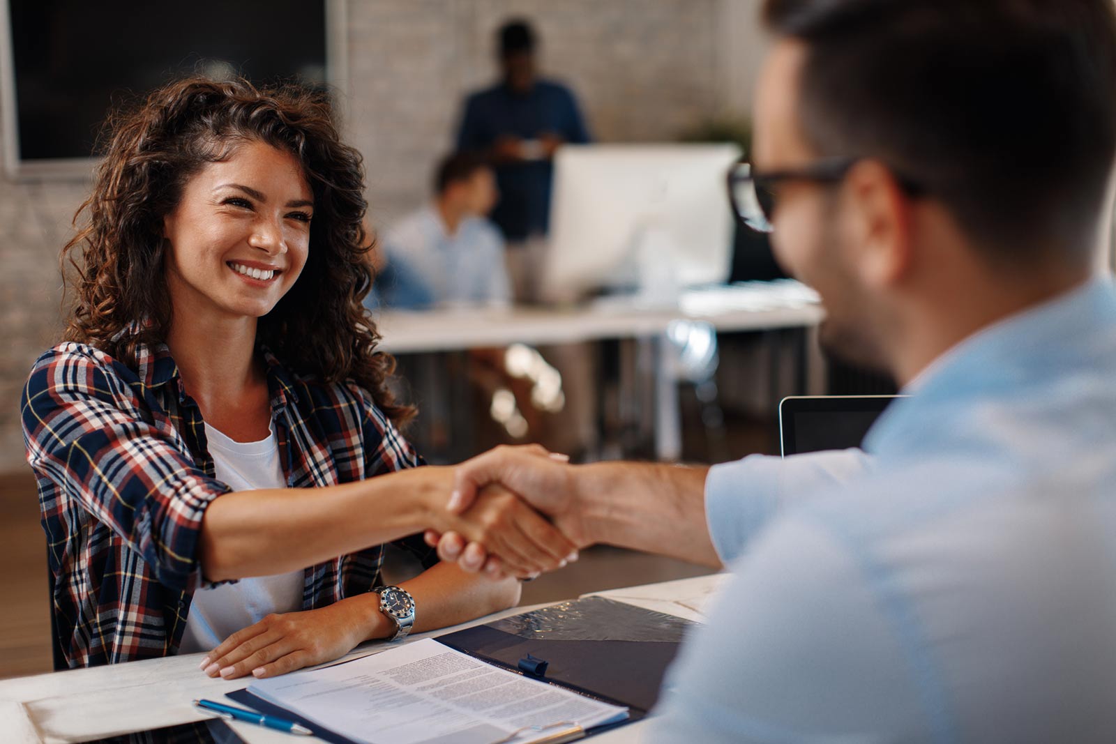 Woman and man shaking hands in an office