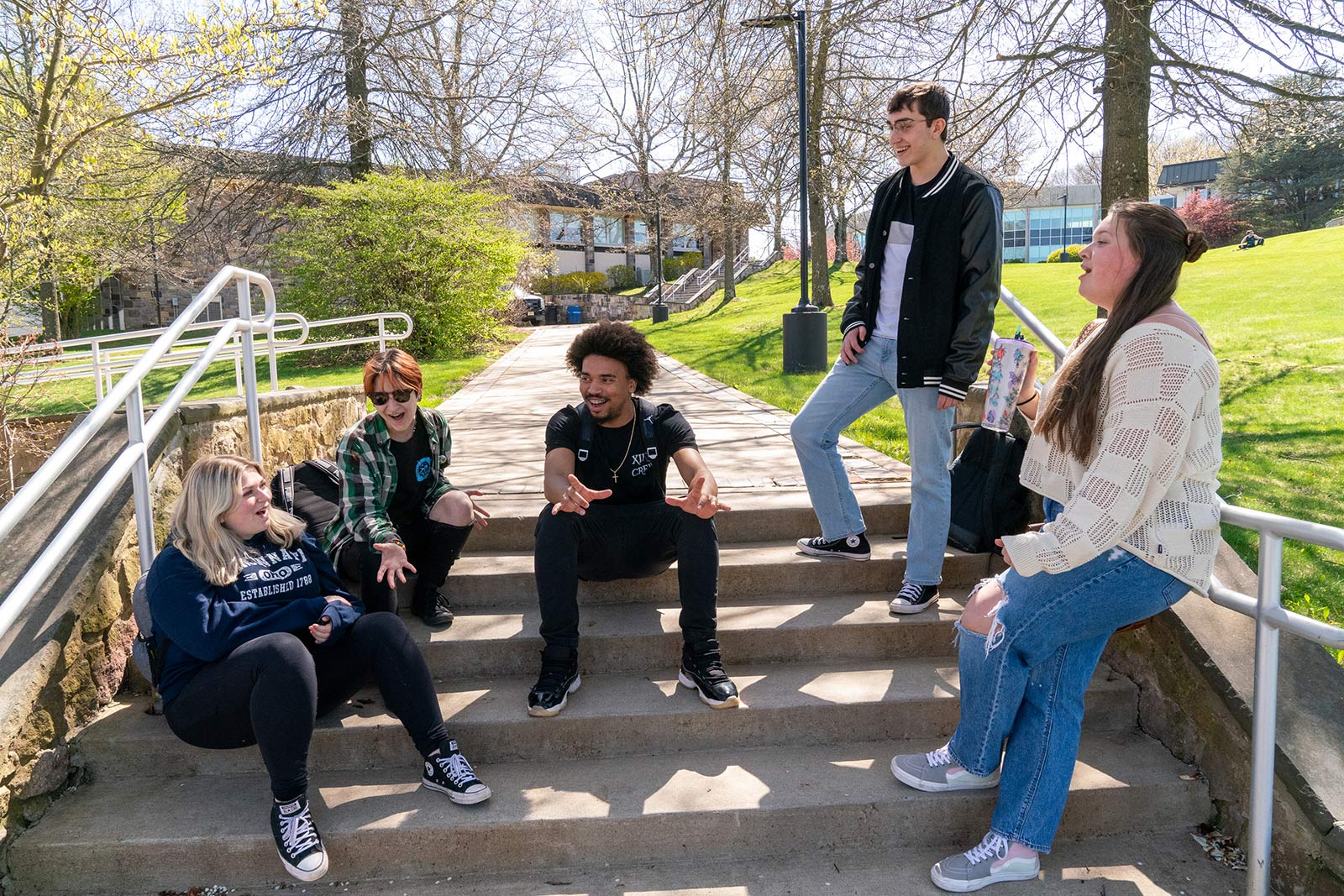 Students sitting on stairs outside on campus